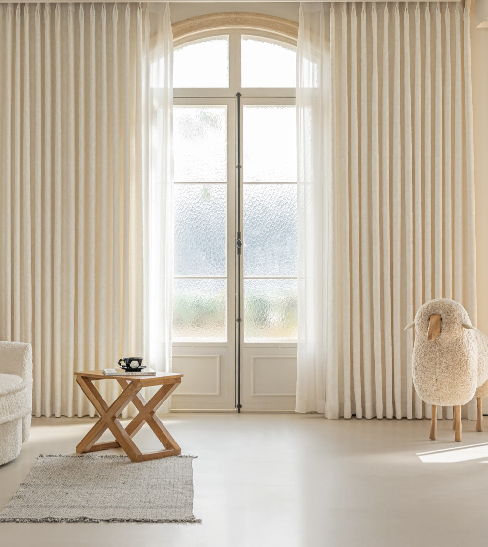 French embossed white blackout curtains in living room with elegant decor.