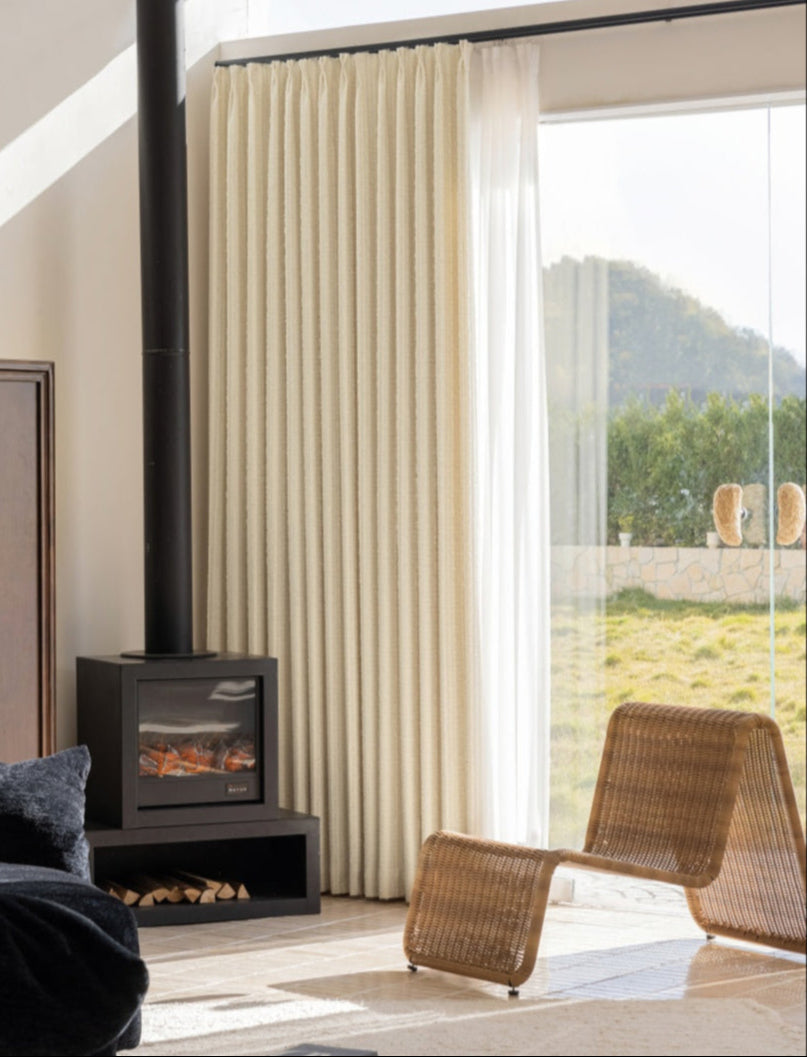 Designer white blackout curtains with subtle stripes, inspired by Agnes Martin, enhancing minimalist interiors.