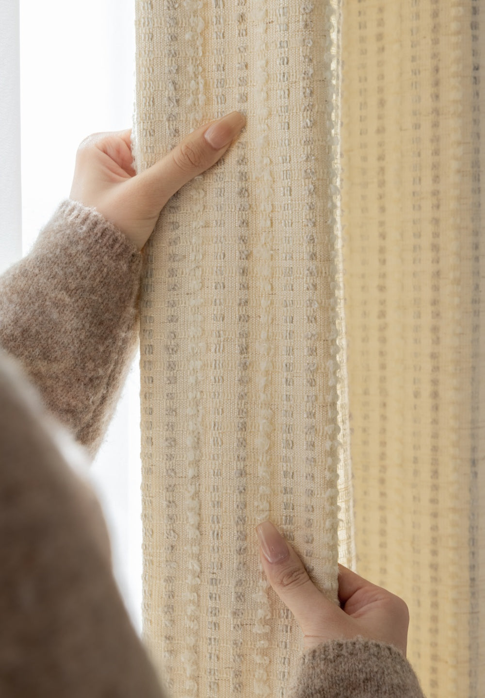 Agnes Martin-inspired white blackout curtains with subtle stripes, minimalist design, hands adjusting fabric.
