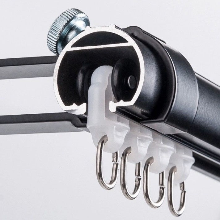 Close-up of customizable extra-long curtain rod with sliding glides and aluminum construction.