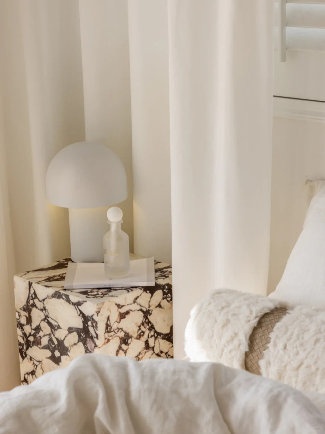 White sheer curtain providing privacy and soft ambiance in a cozy room setting.