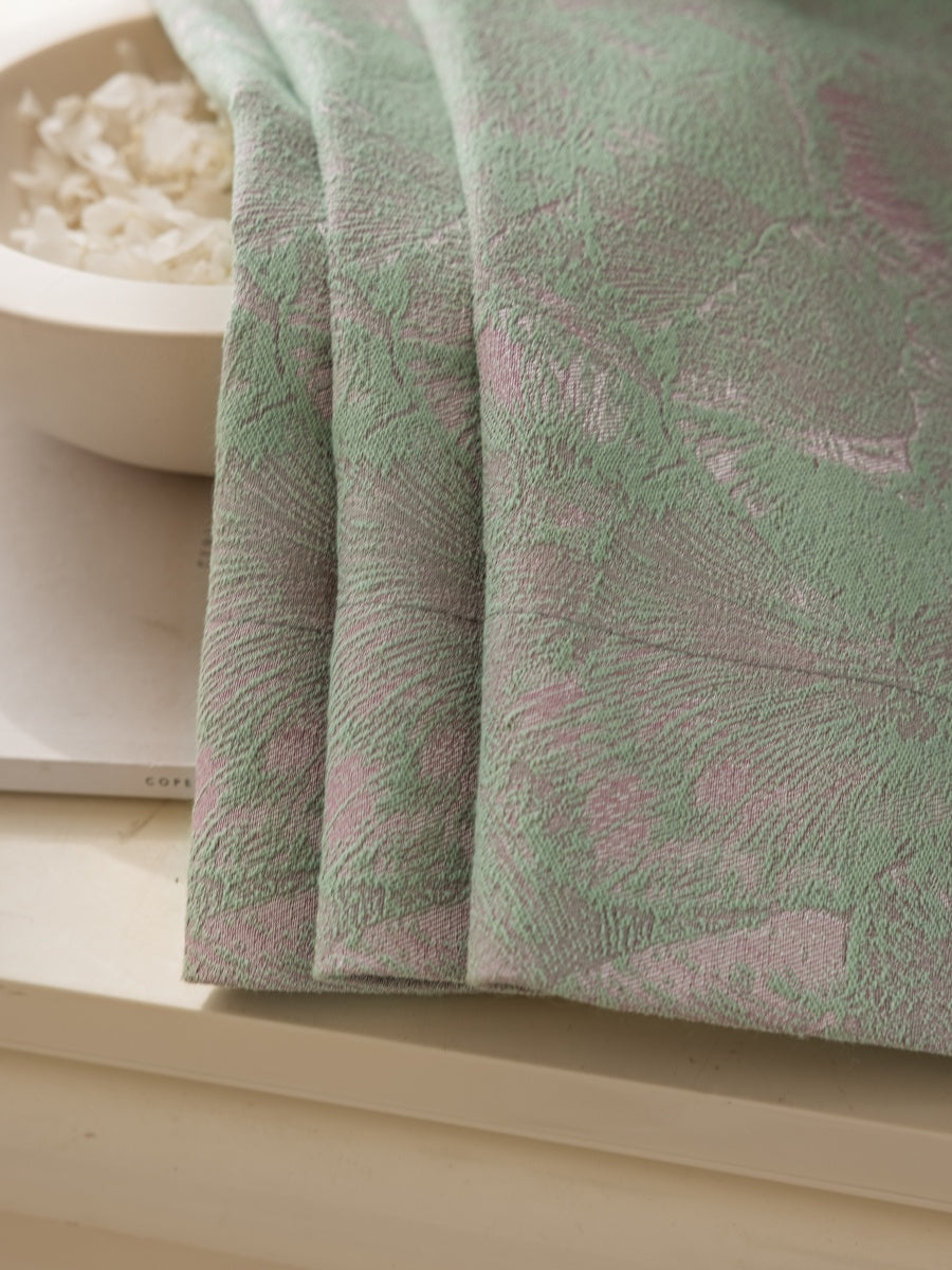 Close-up of green and pink ginkgo leaf jacquard curtain fabric with textured three-color design and blackout feature