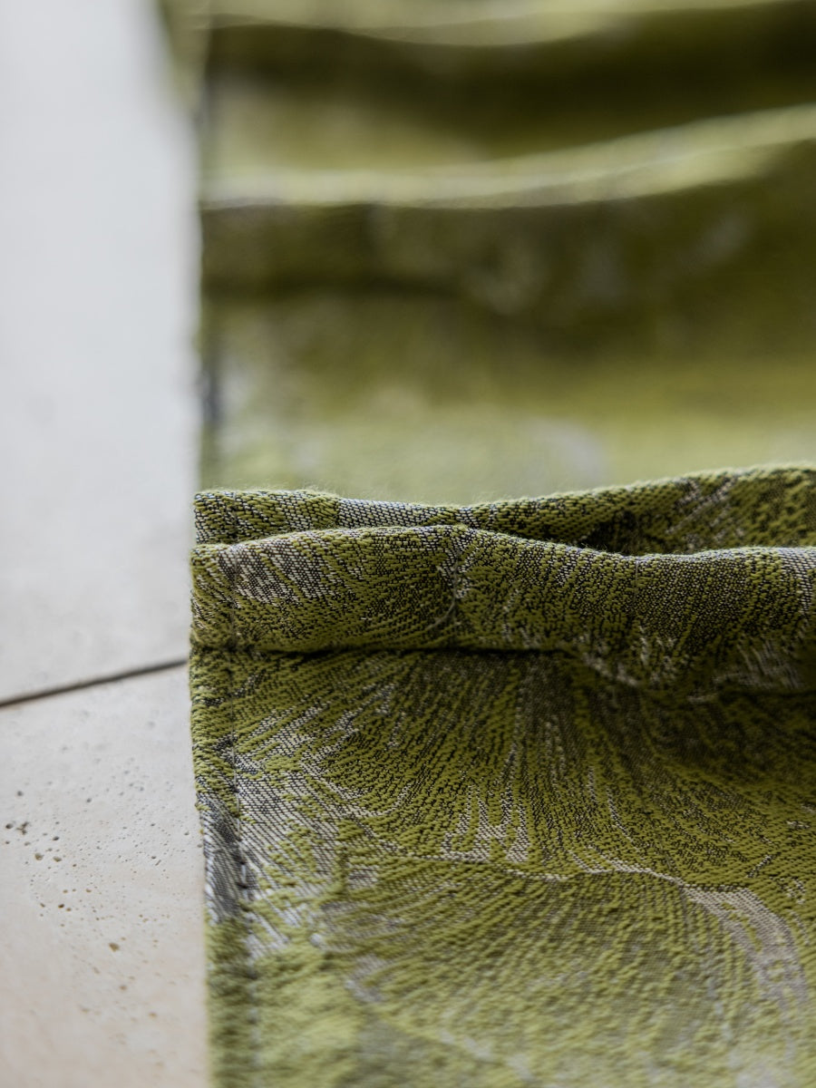Close-up of green ginkgo leaf jacquard curtain fabric showcasing textured cotton and silk threads