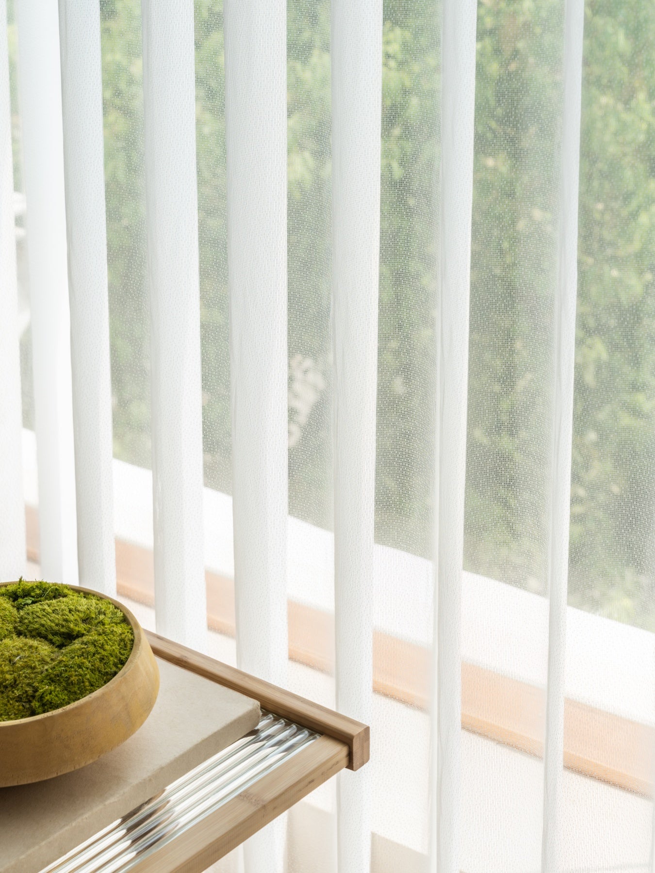 Premium sheer curtain panels on large window, light-diffusing design.