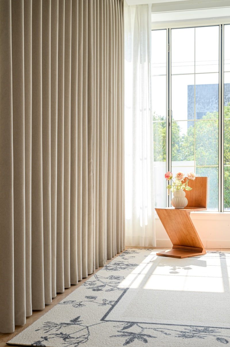 Luxury cashmere texture blackout pleated curtains in a well-lit living room.