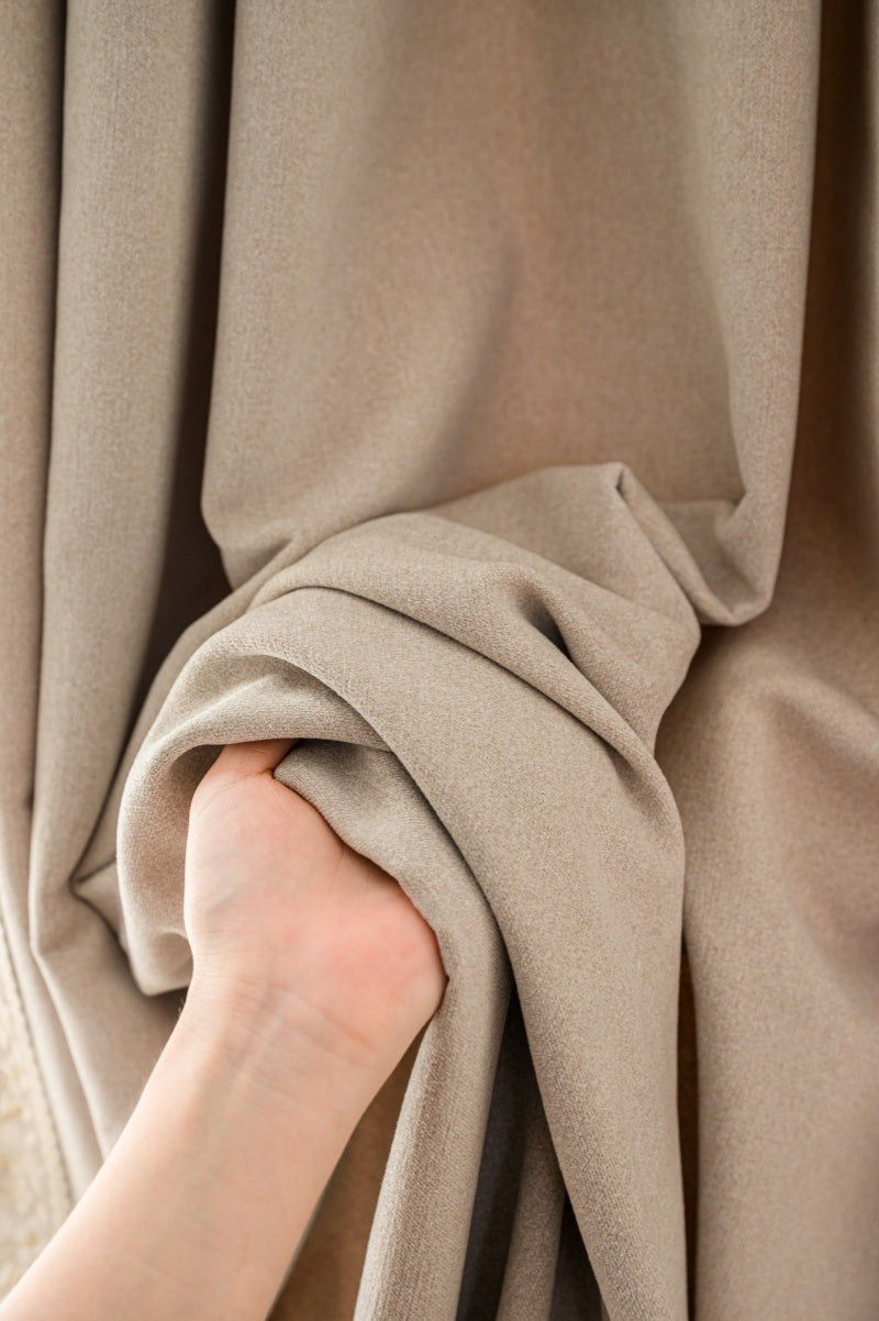 Luxury cashmere texture blackout curtains in beige, showing soft and thick fabric draping.