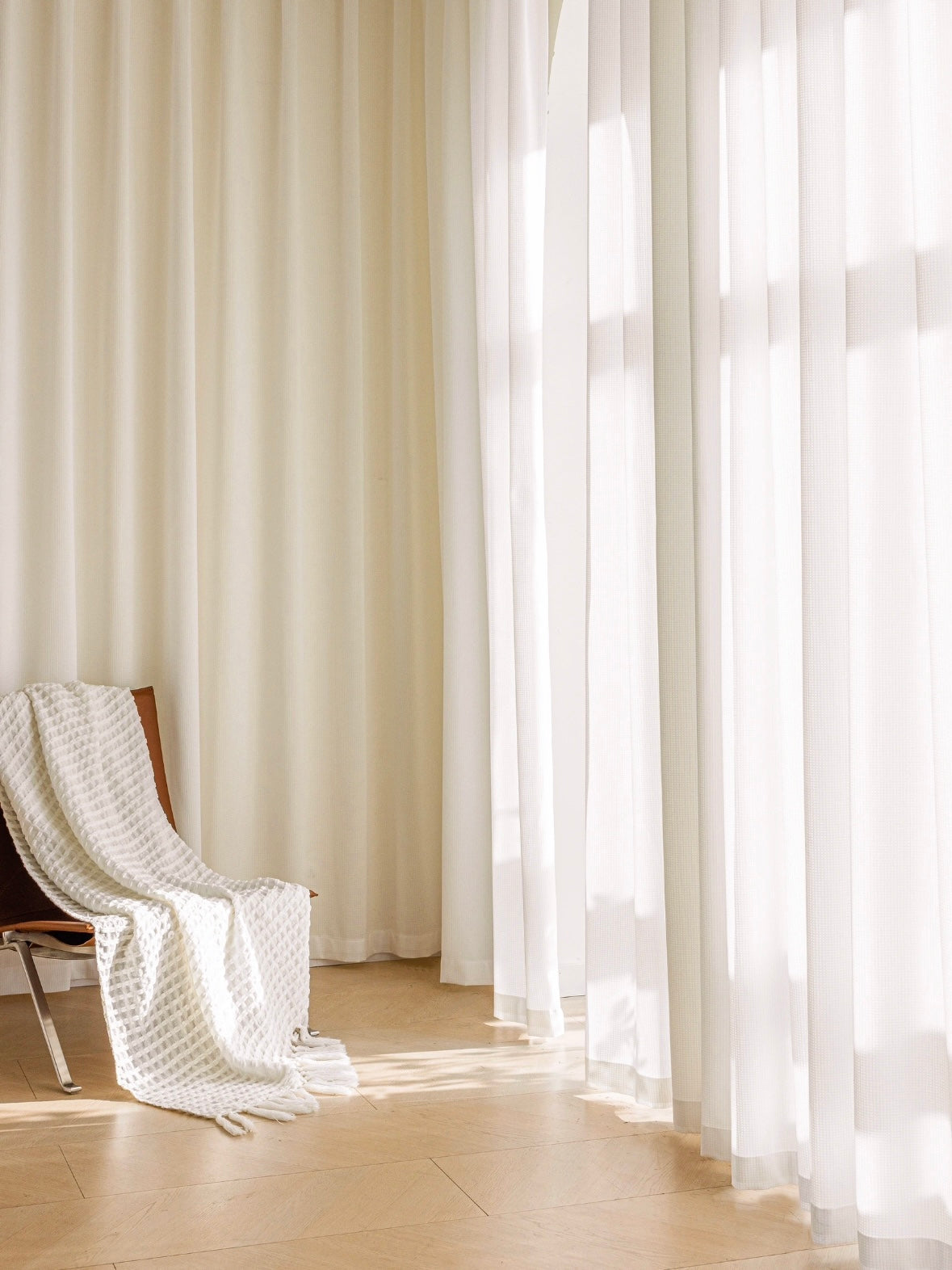Ultra-thin white voile curtains in a sunlit room, showcasing airy elegance and soft light diffusion.