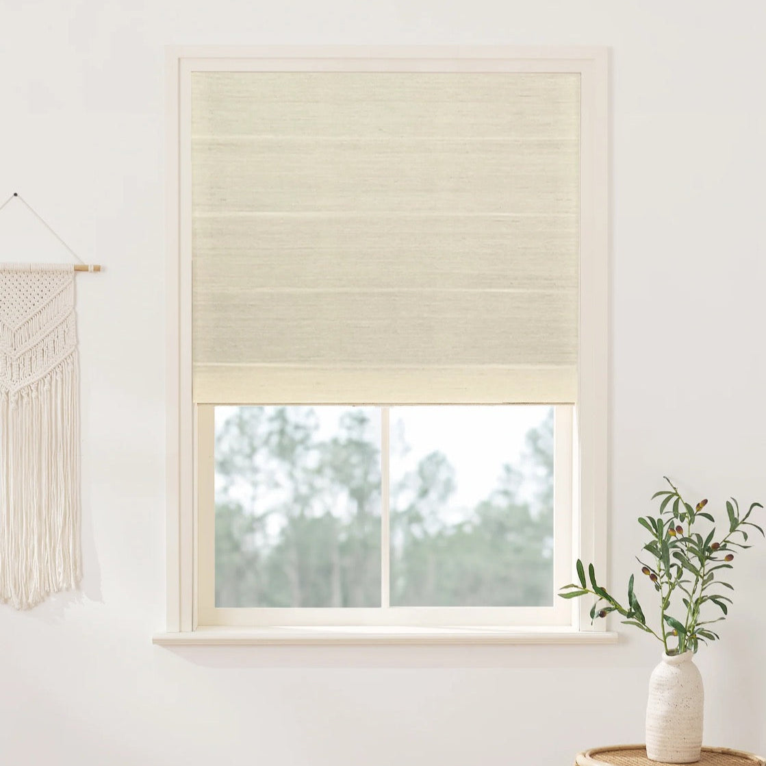 Natural ramie bamboo window shades in coconut white with smooth, woven texture, enhancing light interiors.