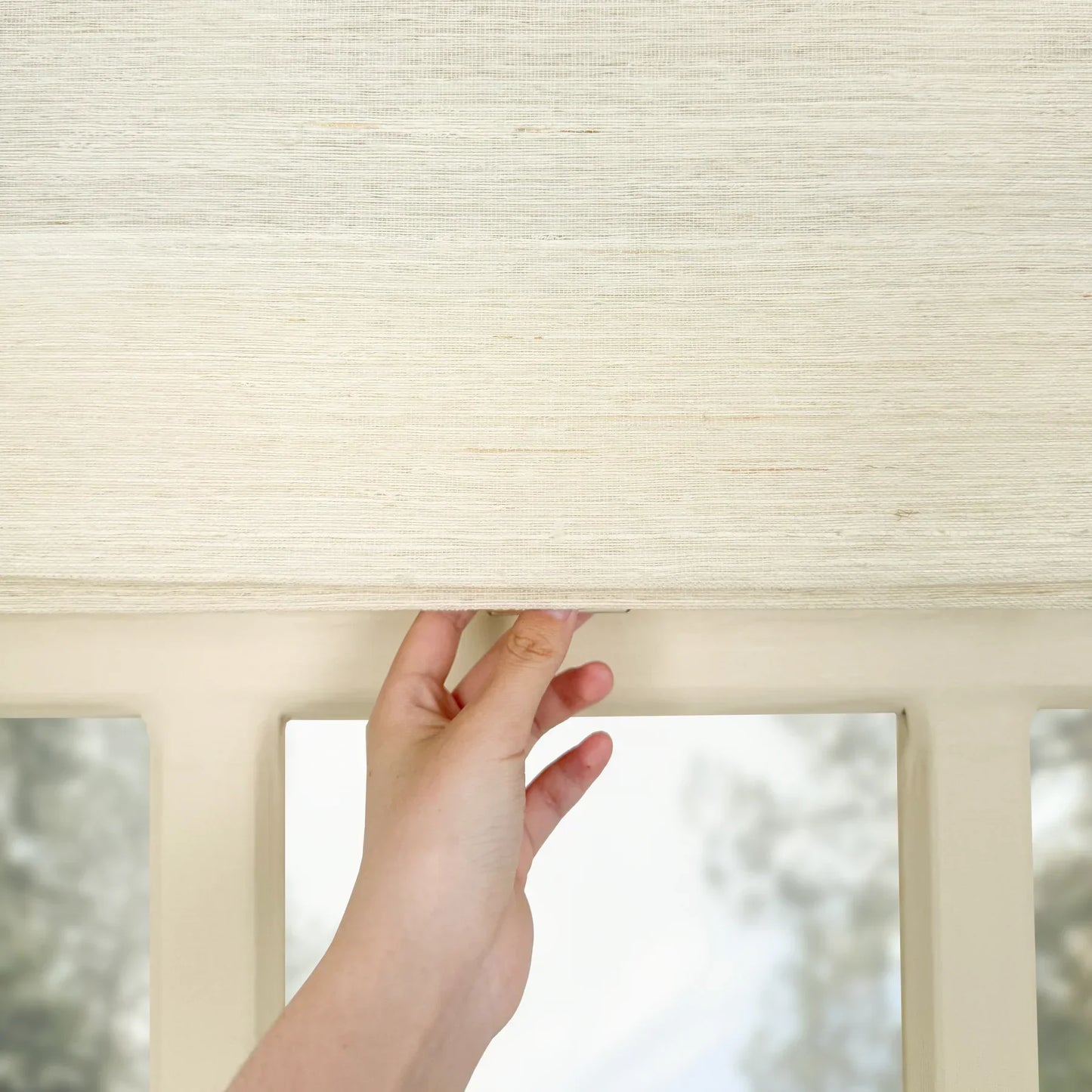 Natural ramie bamboo window shades in coconut white, with a delicate weave and eco-friendly materials.