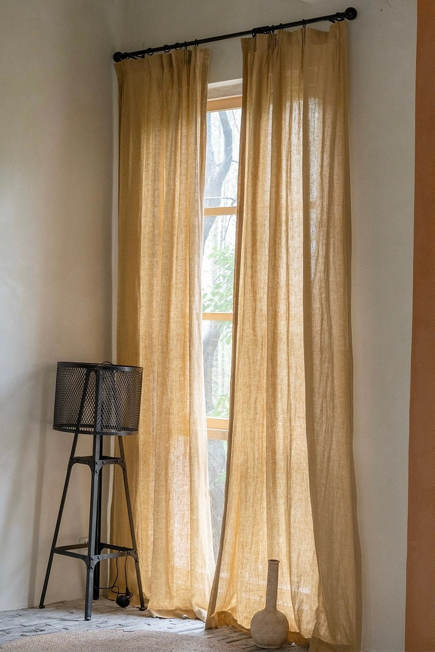 mustard yellow linen curtains hanging by window with soft natural light and minimalist decor