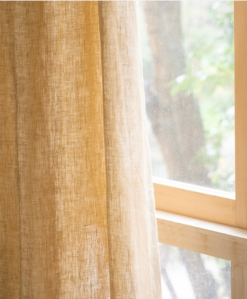Mustard yellow French linen curtains with natural texture and breathable fabric hanging by a window