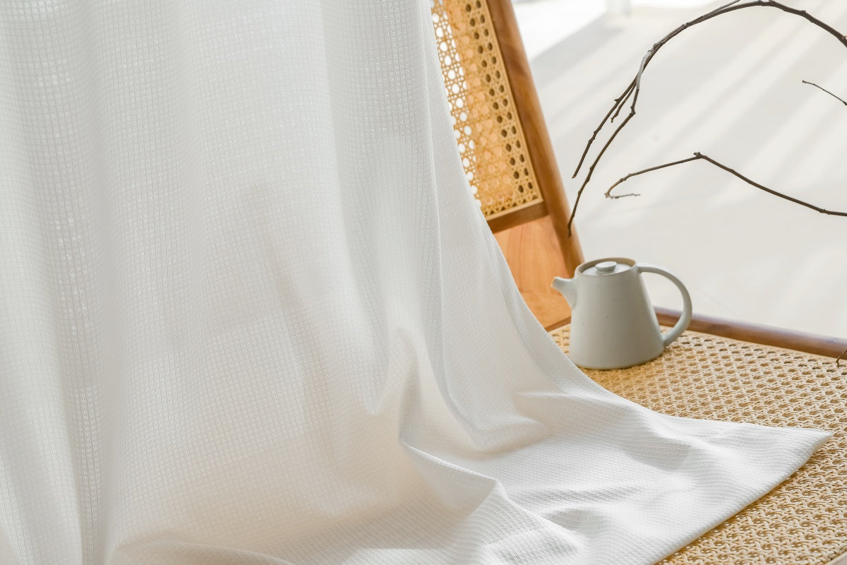 Premium white sun-blocking sheer curtains with waffle pattern in living room setting.