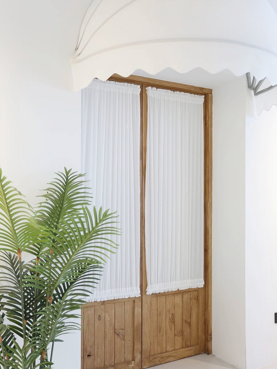 Custom rod pocket French door curtains on wooden doors, providing privacy and style.