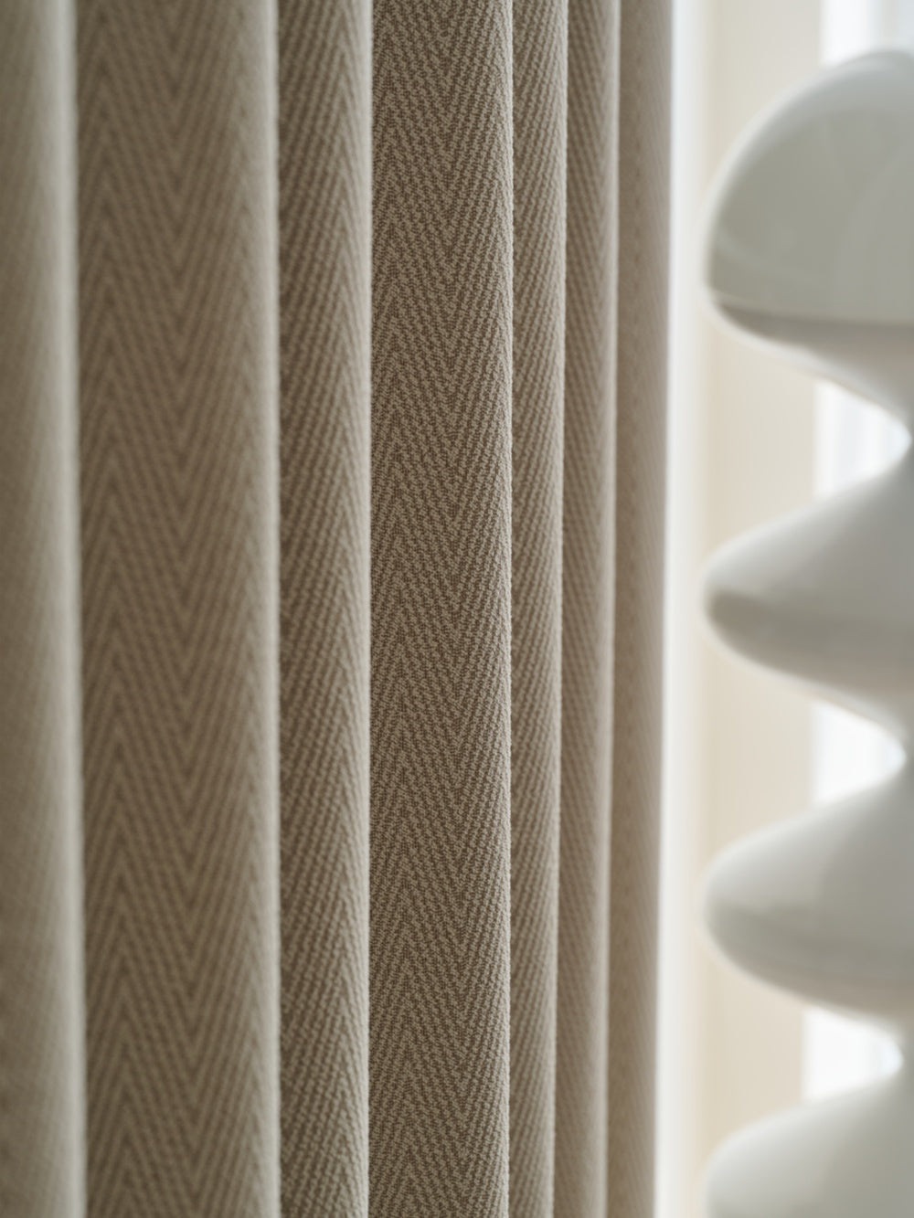 Herringbone blackout curtain close-up with elegant texture and soft fabric for bedroom decor.
