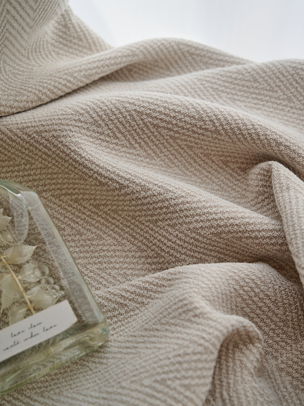 Herringbone blackout curtain fabric close-up, showcasing its soft texture and elegant design for bedroom decor.