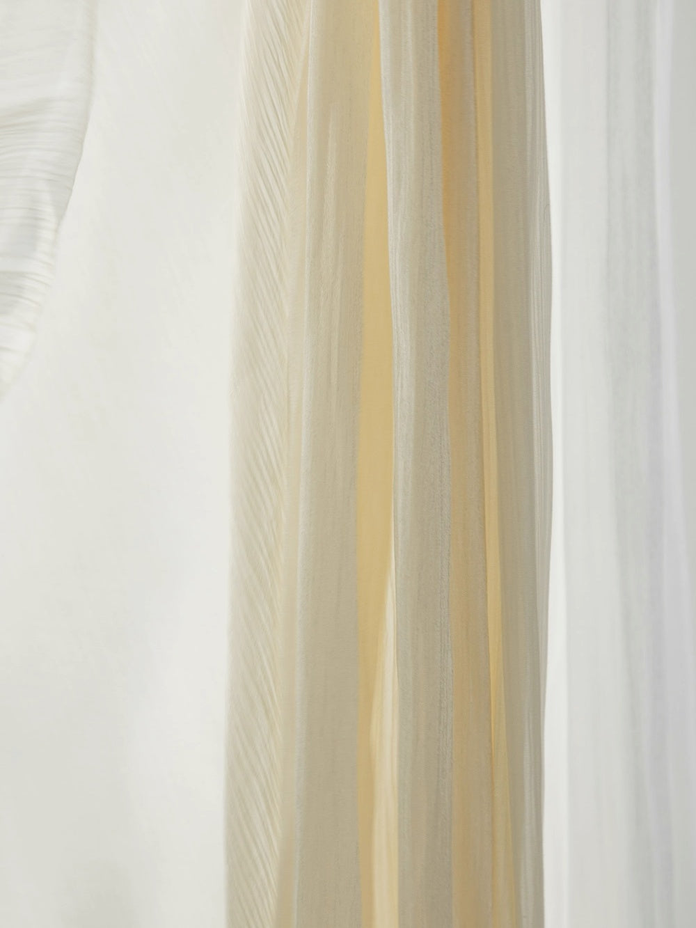 Cream and white sheer curtains with shimmering pearl finish for sunrooms.