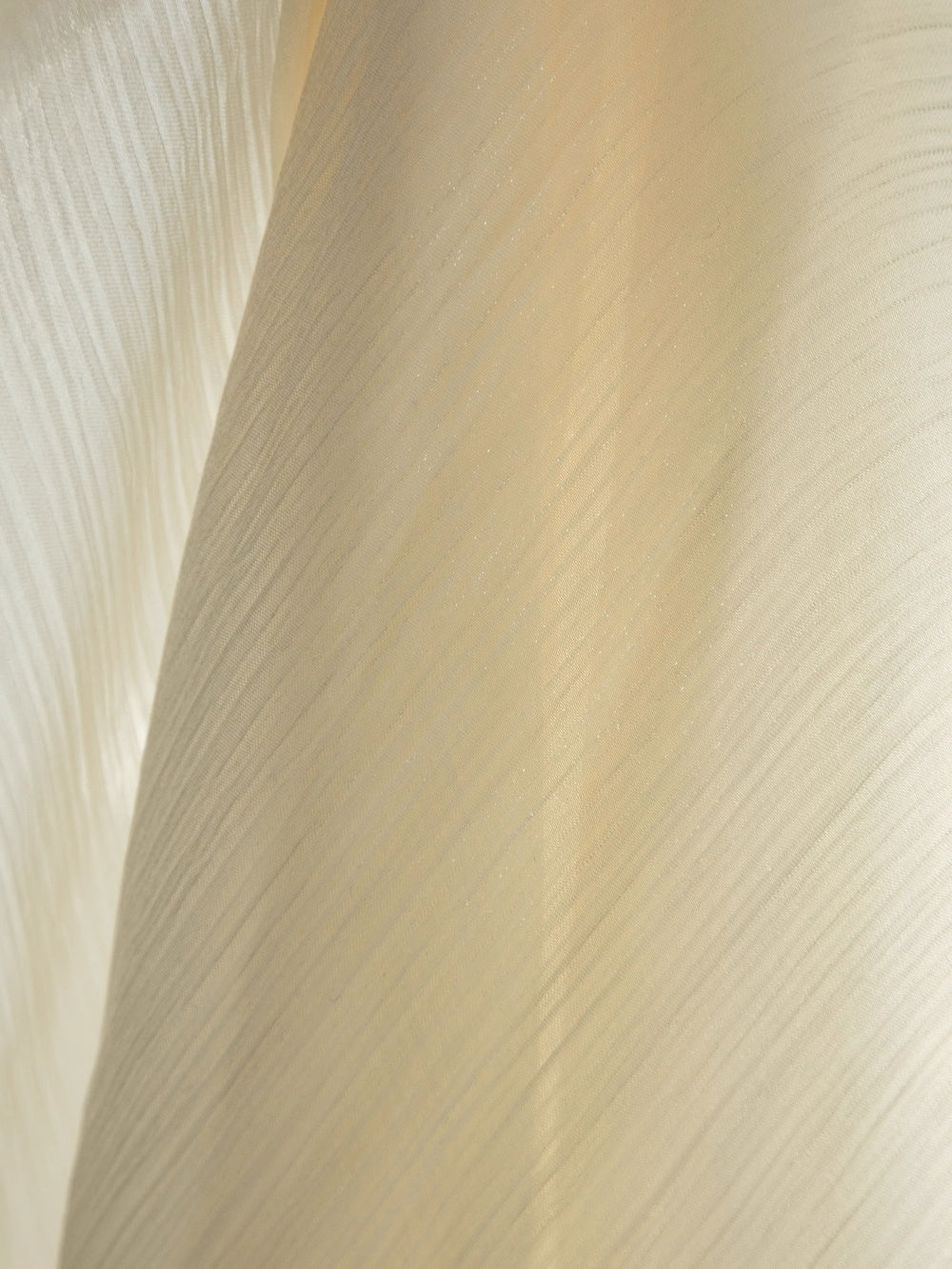 Sheer curtains with shimmering pearl finish in cream color for sunrooms.