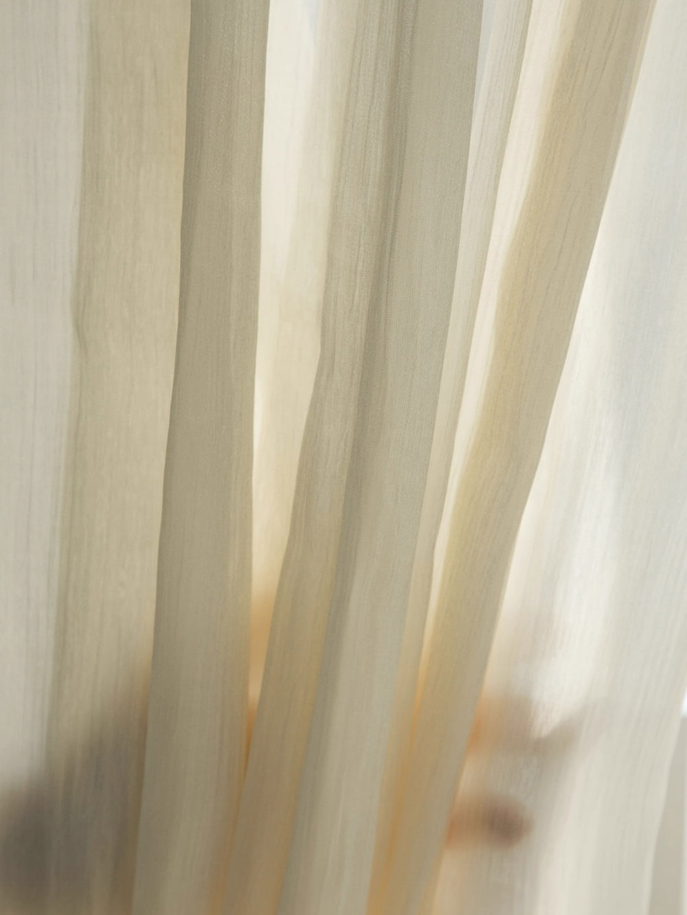 Cream sheer curtains with shimmering pearl finish for sunrooms, offering privacy and elegance.
