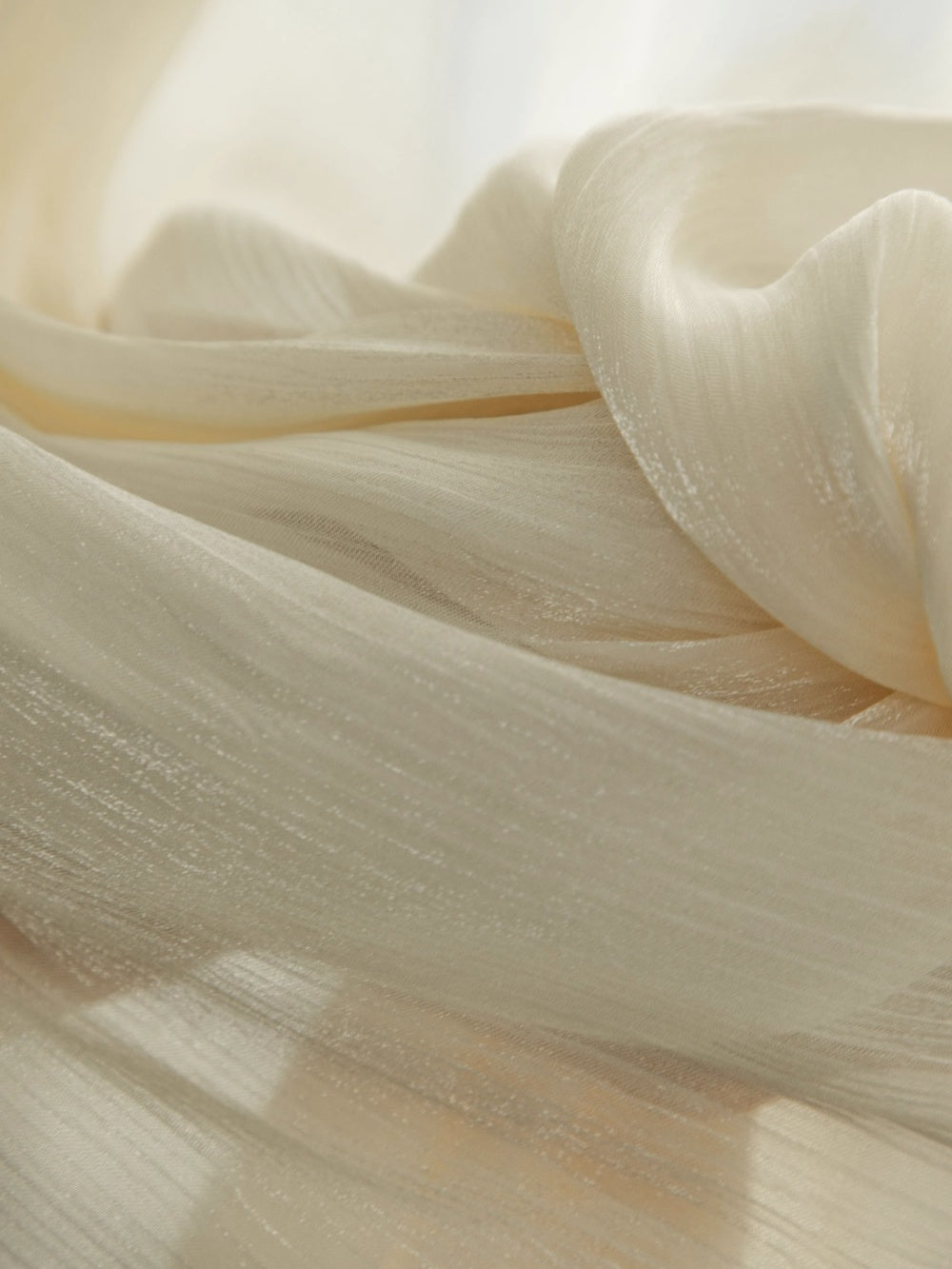 Cream sheer curtains with shimmering pearl finish for sunrooms.