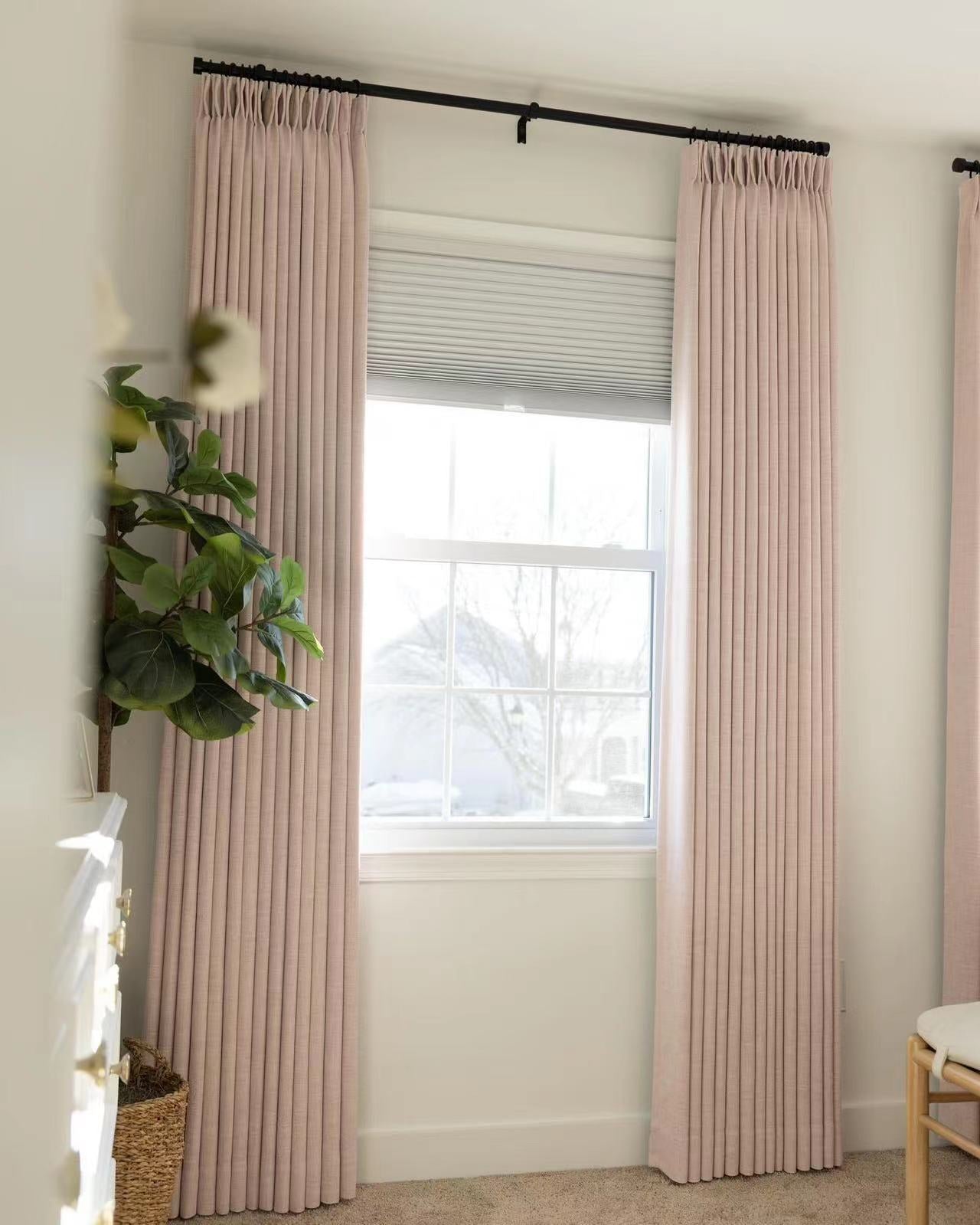 Pinch pleat linen blackout curtains in soft neutral shade, enhancing room decor while ensuring privacy.