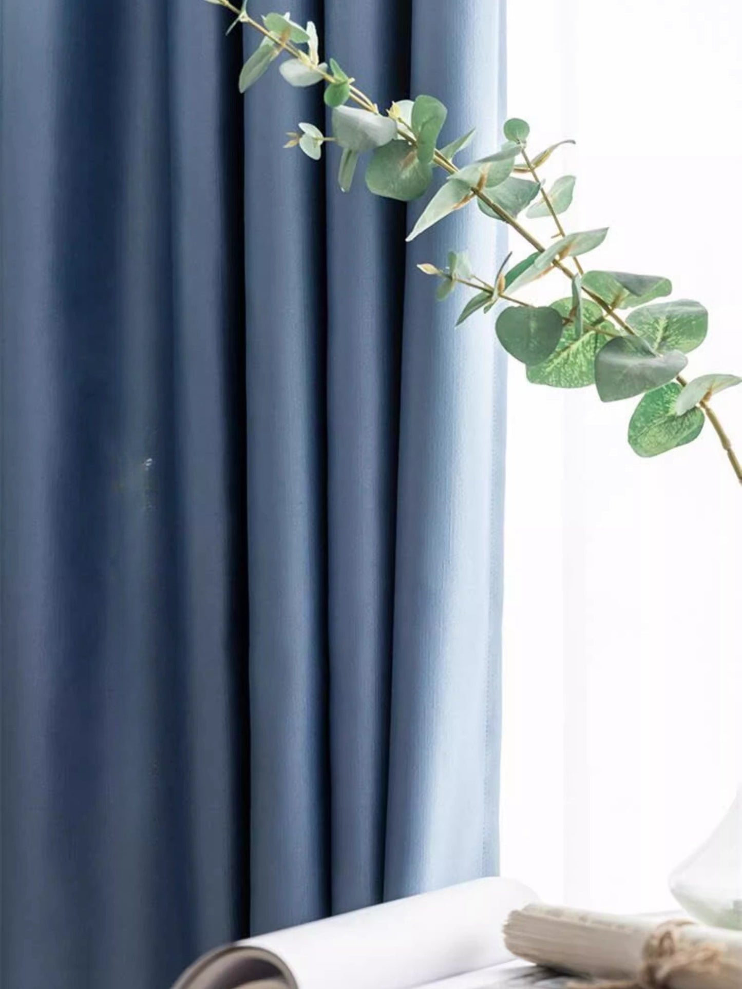 Blue silk curtains with smooth draping and elegant texture.