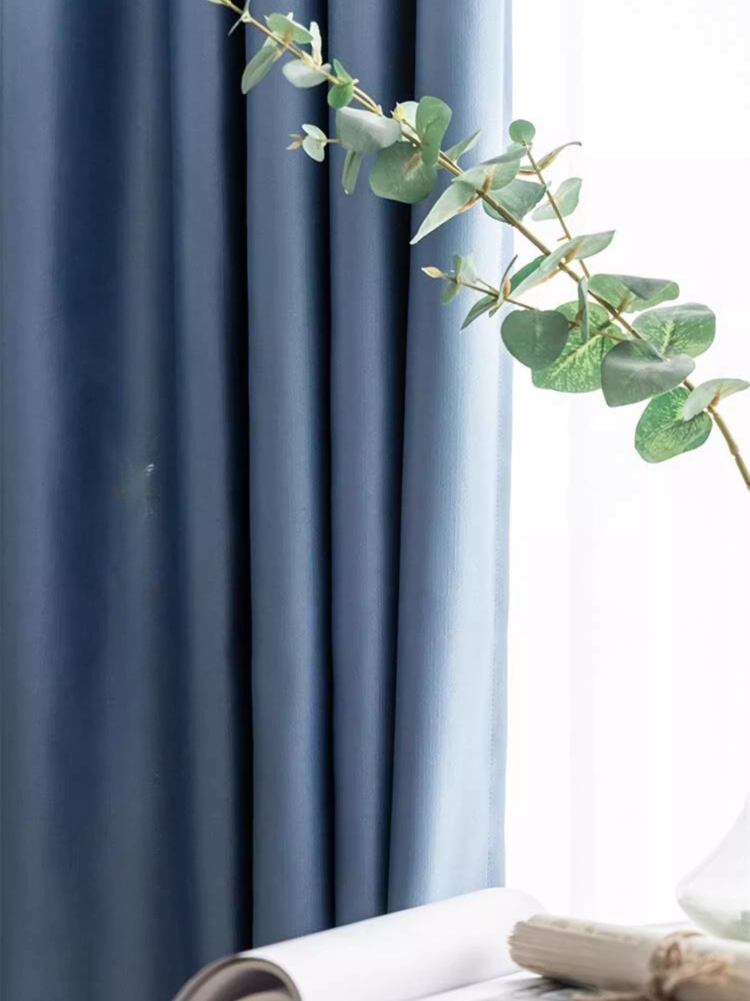 Blue silk curtains with smooth draping and elegant texture.