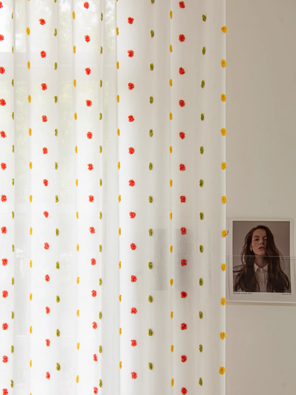 Colorful candy-themed sheer curtains with rainbow pom-poms, perfect for kids' rooms.