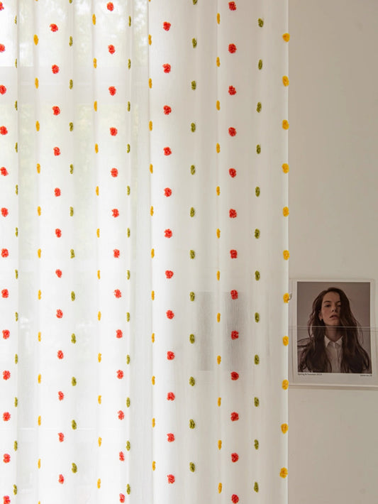 Colorful candy-themed sheer curtains with rainbow pom-poms, perfect for kids' rooms.