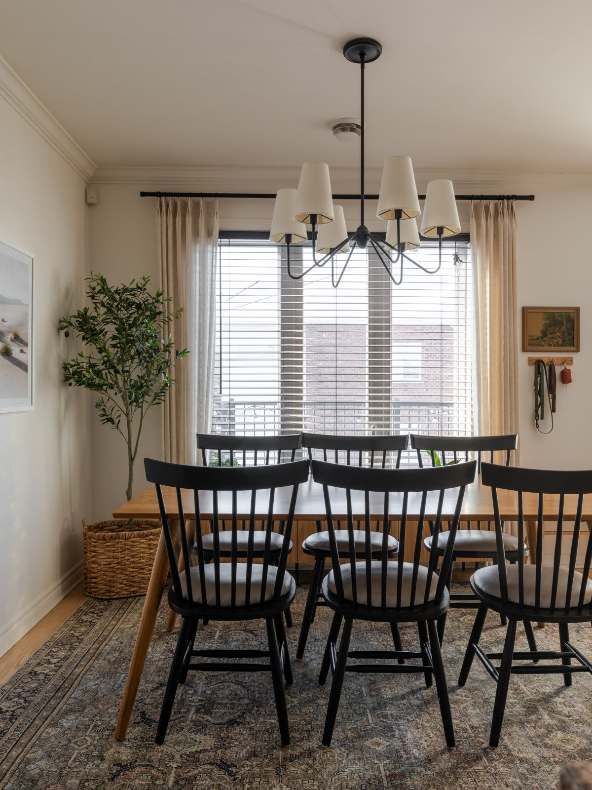 Linen-wool blend sheer curtains in elegant living room with black chairs and chandelier.