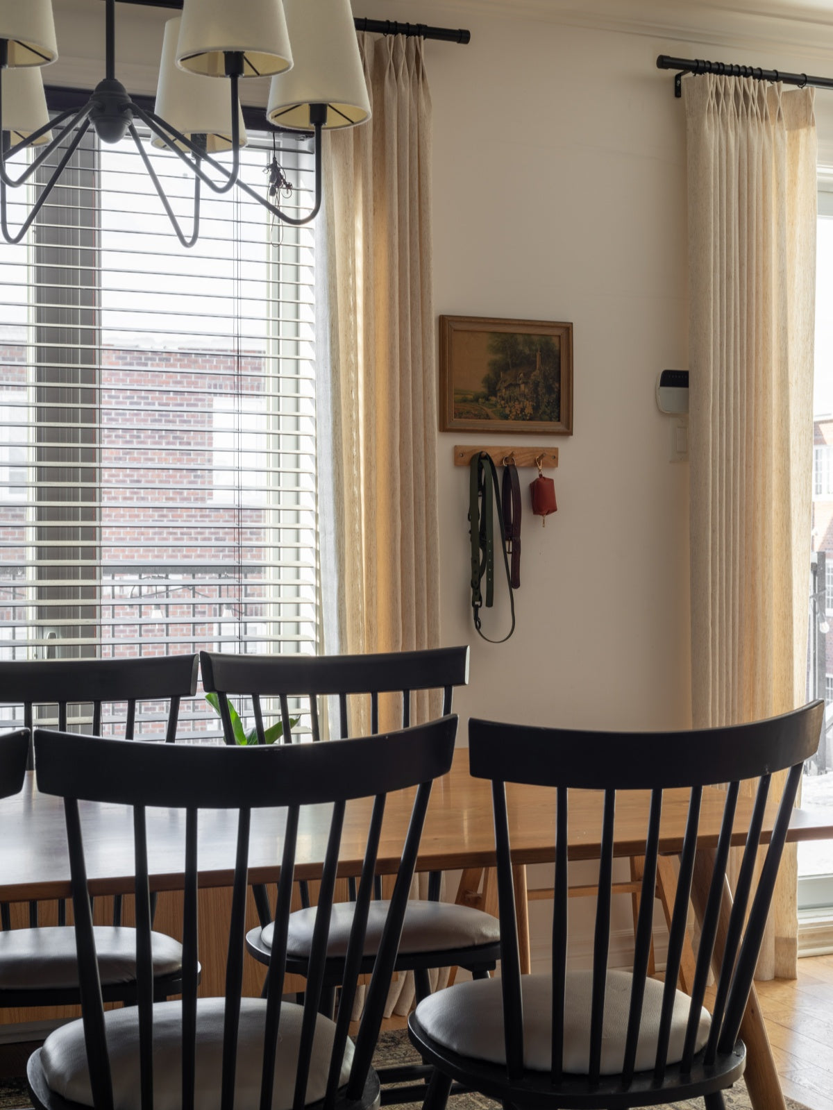 Linen sheer curtains in beige hanging floor to ceiling, ideal for living room and bedroom windows.