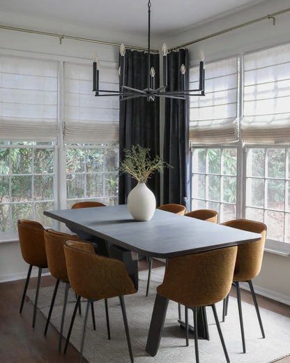 Dining room with cordless custom roman shades and modern chandelier over table with six brown chairs