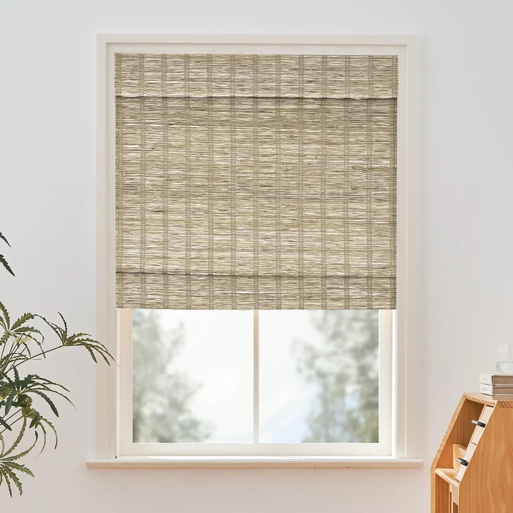 Natural woven jute bamboo shades with cinnamon tone installed on window.