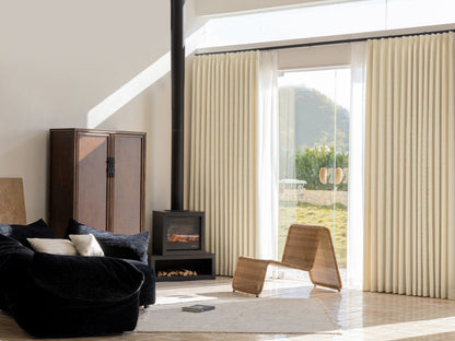 Designer white blackout curtains with subtle stripes in a modern living room.