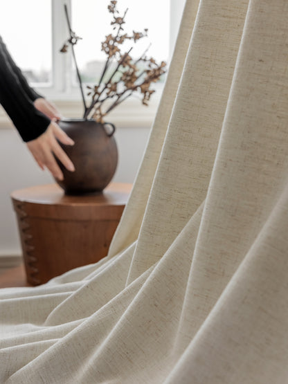 Luxurious white French linen blend drape with subtle texture in an elegantly designed living space, featuring a rustic vase on a wooden stool
