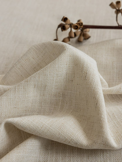 Close-up of luxurious white French linen blend drape with subtle texture and dried floral accent, perfect for sophisticated home interiors