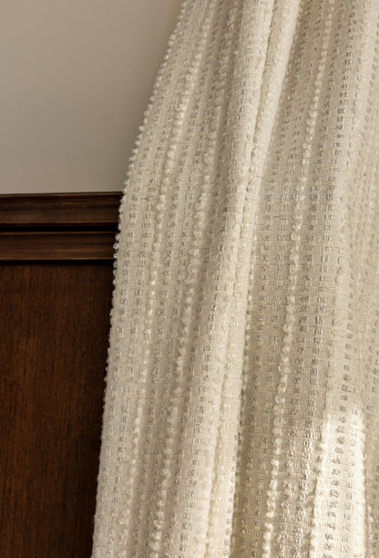 Designer "Agnes Martin" white blackout curtains with subtle stripes and textured fabric.