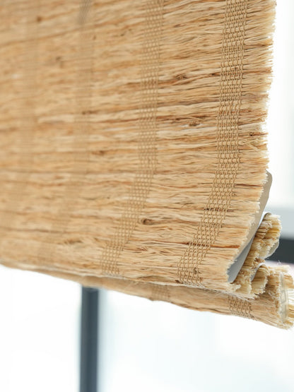 Honey-colored natural ramie woven shades with breathable weave and textured finish for modern and rustic home decor