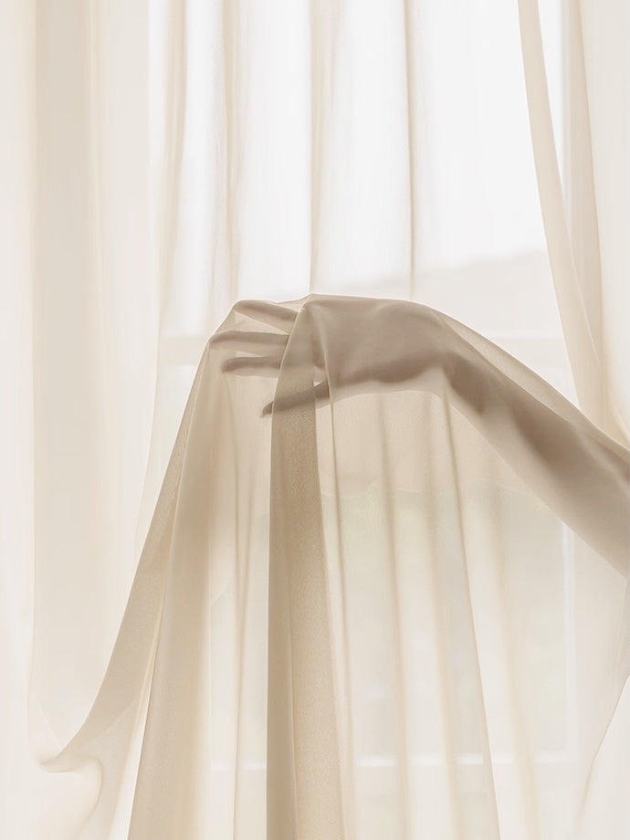 Cream sheer curtains with ruffled hem for princess room ambiance.