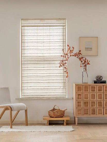 Ivory sand natural ramie bamboo blinds in a bright, minimalist living room with wooden furniture and neutral decor