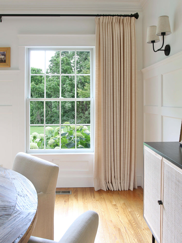Linen blackout curtains in a bright room, enhancing décor and functionality.