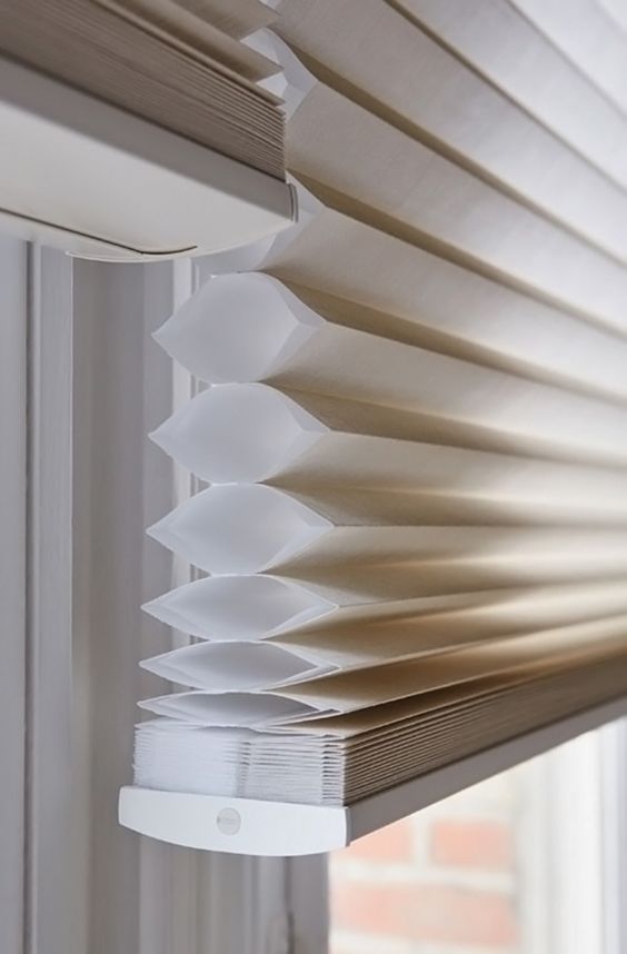 Close-up of white top-down bottom-up honeycomb shade in a window, showcasing smooth texture and adjustable design for optimal light control and privacy