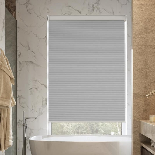 Grey honeycomb blind shade in a luxurious marble bathroom, providing privacy and light control, ideal for sophisticated home decor