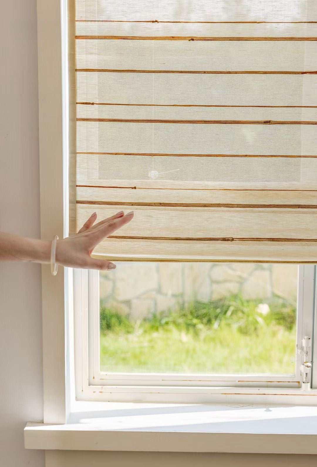 Natural Ramie Bamboo Blinds on window filtering light.