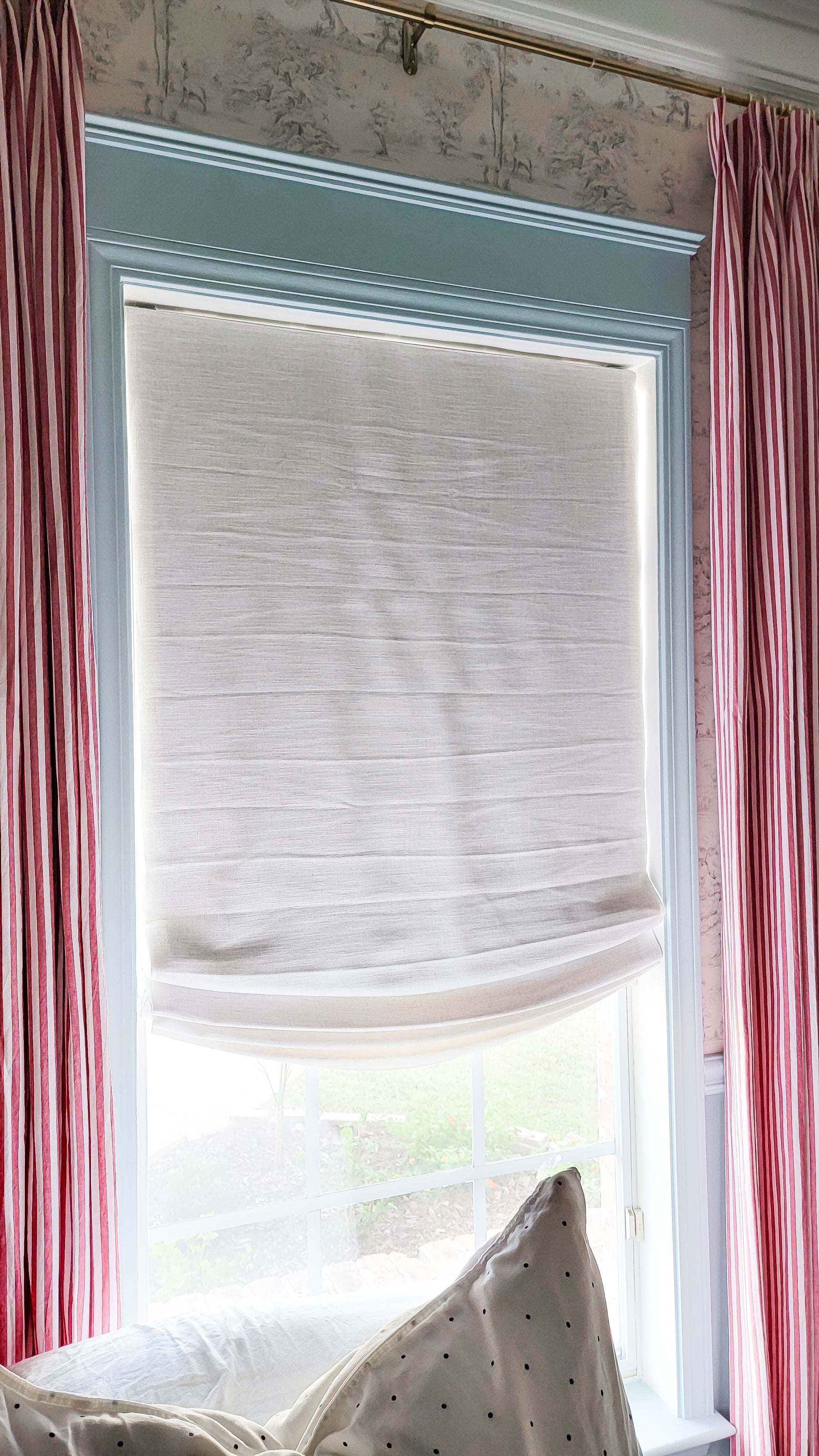 Custom relaxed roman shades in white linen with soft curved bottom, light filtering window treatment in modern home.