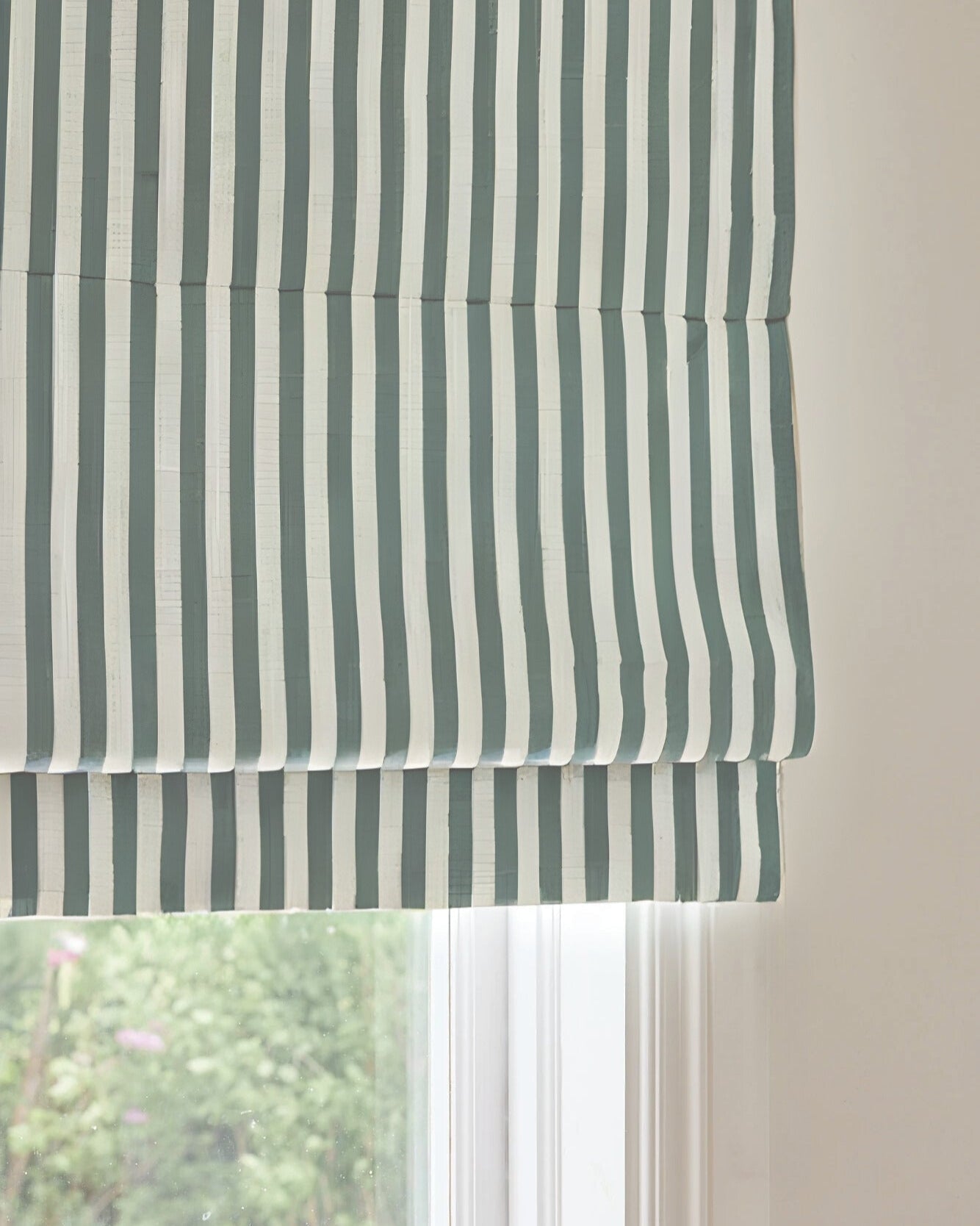 Custom striped roman shades with cordless lift, light filtering, and blackout options for child-safe window treatment