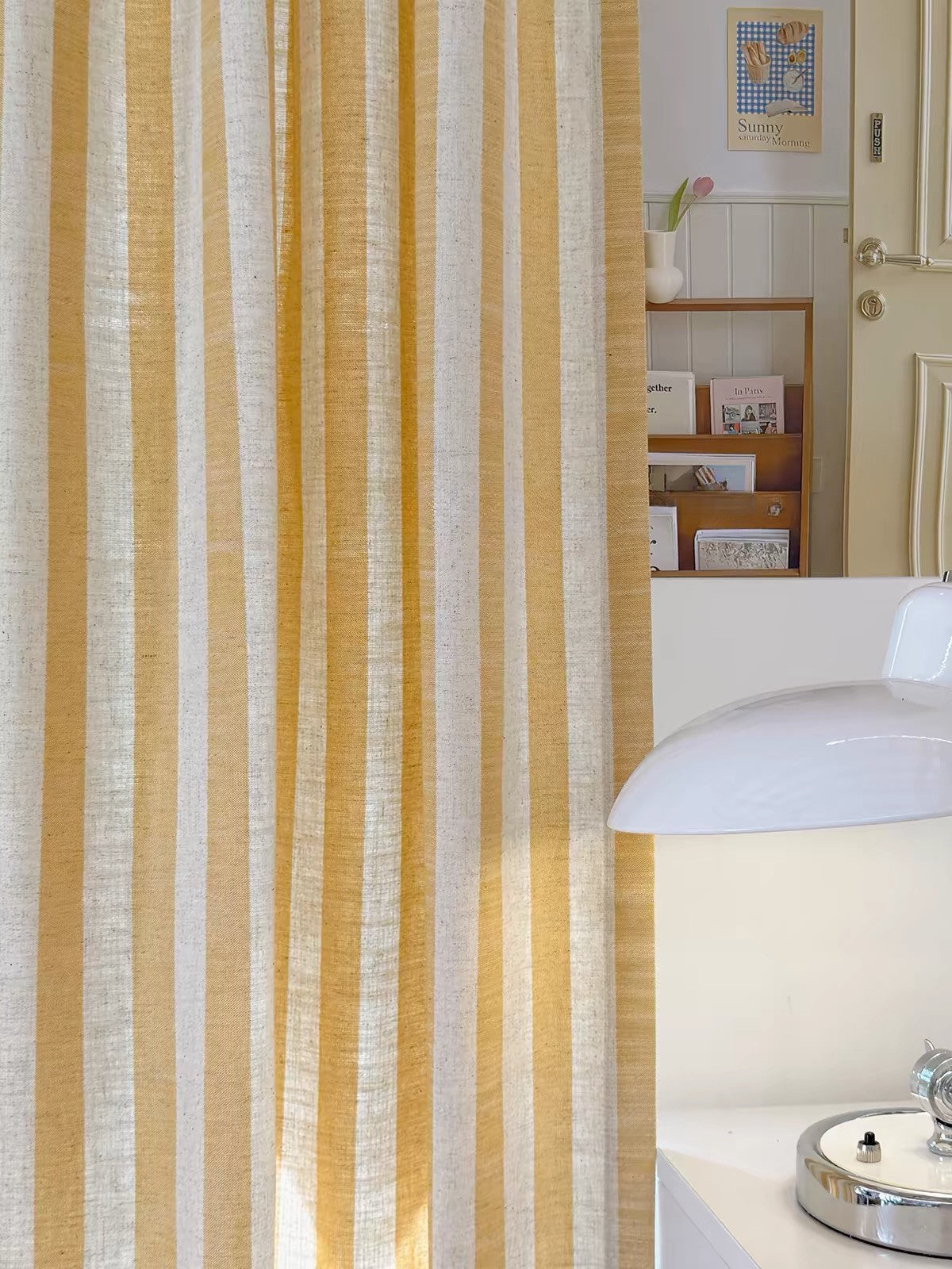 Close-up of butter yellow and white striped linen curtain fabric in a kids bedroom