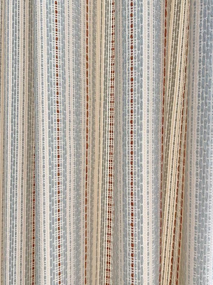 Striped curtains with jacquard weaving in beige and blue for playroom decor.