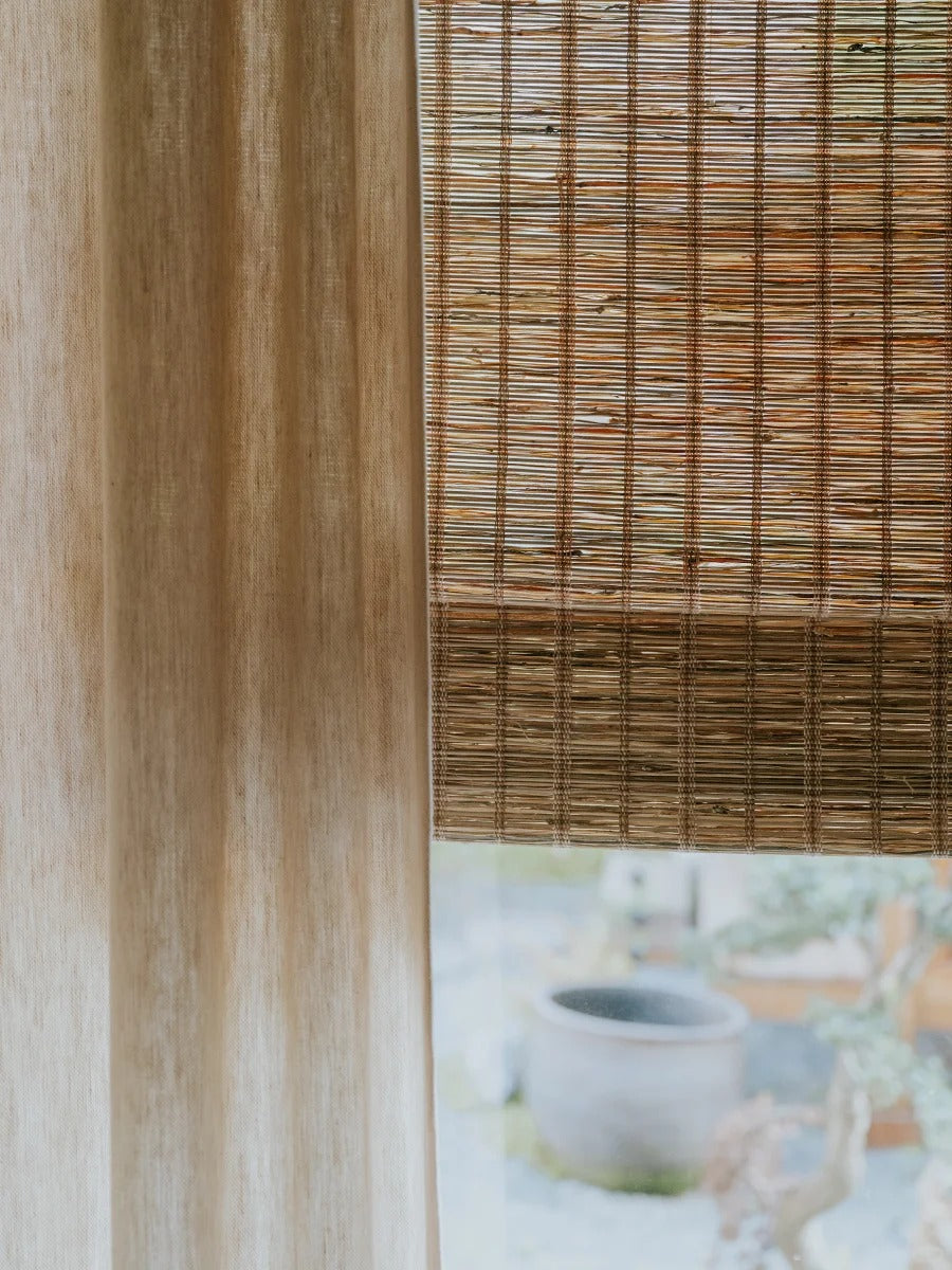 Natural jute and bamboo shades in rich cinnamon, handwoven outdoor Roman shades with breathable, sustainable fibers