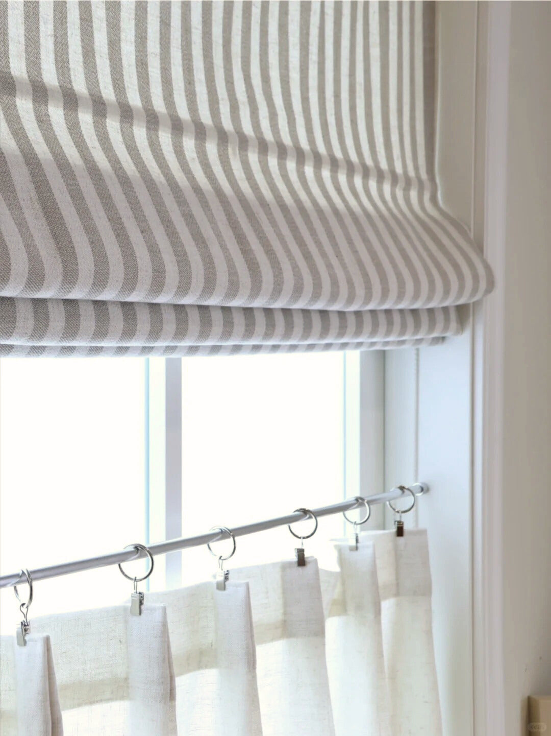 striped roman shades with cordless lift in light filtering fabric on window