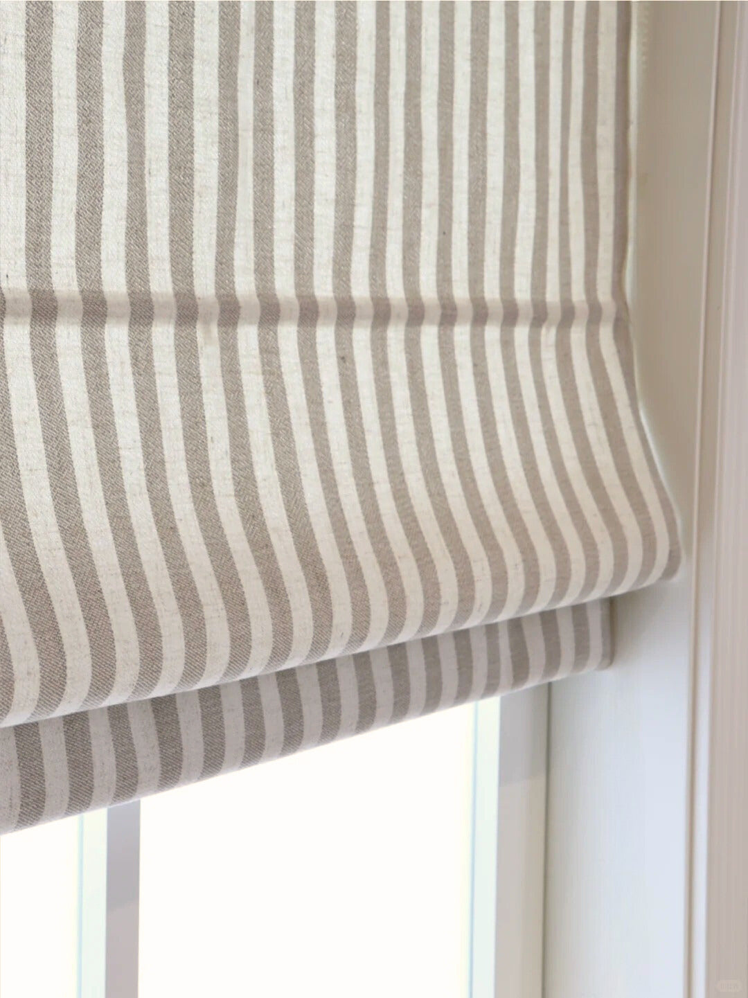 Striped Roman Shades with cordless lift in classic beige and white stripes, light filtering fabric